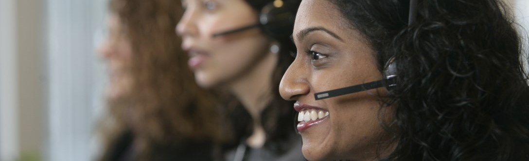 Three customer service reps on headsets 