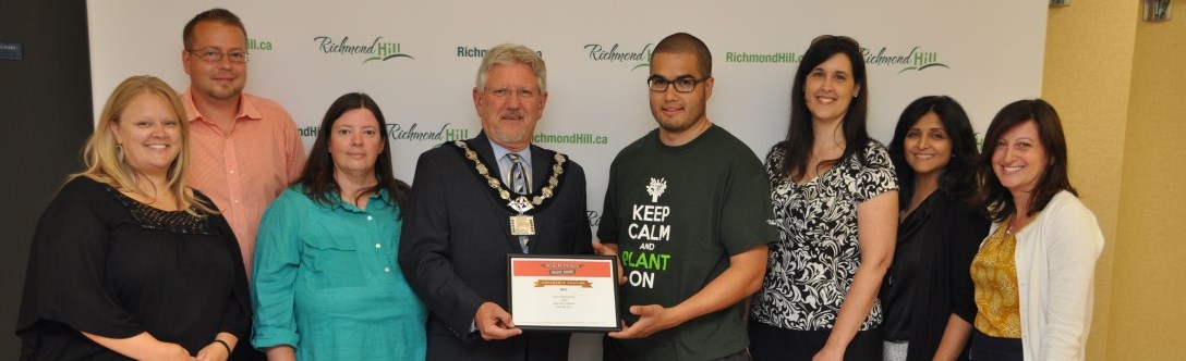 Mayor and staff holding award recognition