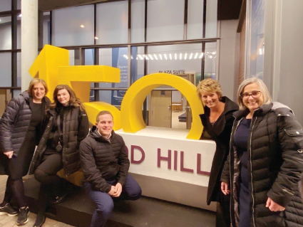Richmond Hill Event Services Team standing in front of RH150 sign