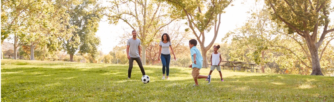 image of family playing in park