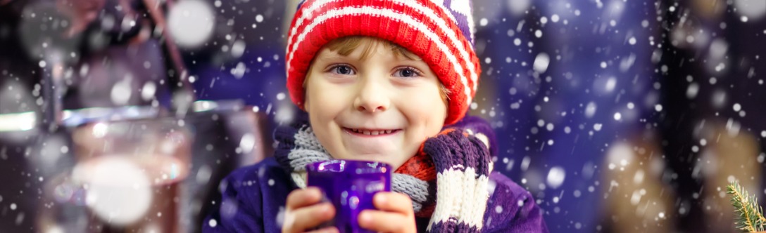Boy sipping hot chocolate winter background