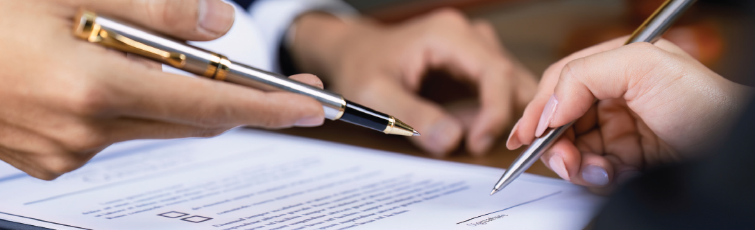 People engaged in a discussion and signing papers
